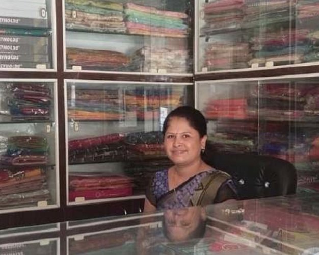 A founder working at an industrial sewing machine on patterned fabric