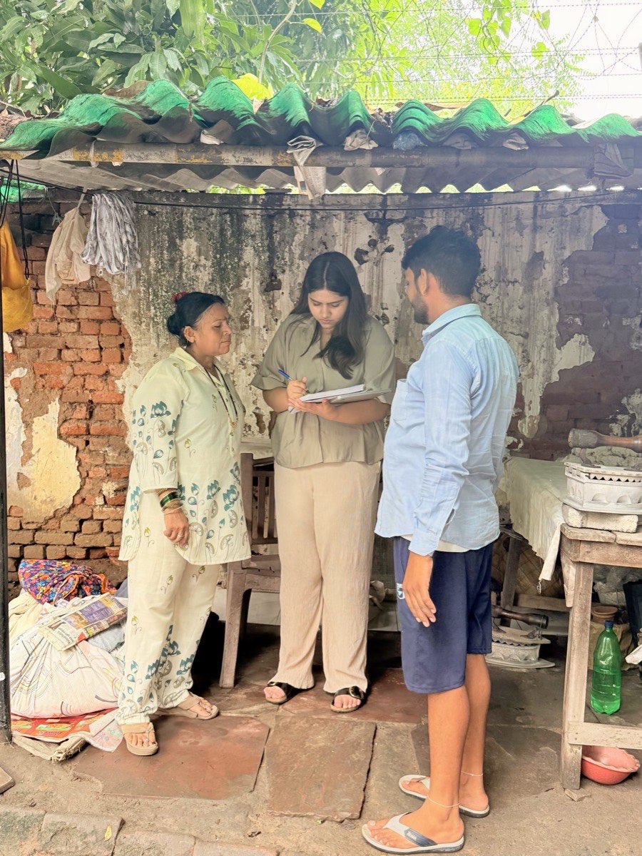 RISE team member taking notes during a field visit to a home-based business
