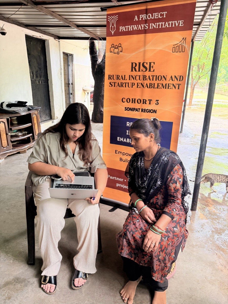 A founder reviewing her registration details with a RISE team member
